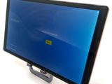a tablet computer sitting on a stand with a blue screen