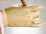 a statue of a hand with a pen in it ' s hand