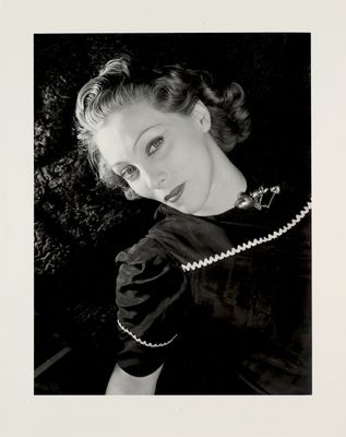black and white photograph of a woman in a dress posing for a picture