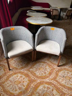 two chairs and a table in the corner of a room