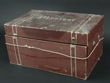 a brown box with writing on it sitting on a black surface