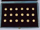 a blue case with gold buttons in it on a white surface