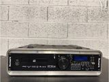 a radio that is sitting on a table in front of a brick wall