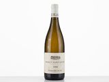 a bottle of white wine sitting on top of a table