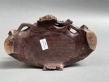 a brown vase with a tag on it sitting on a table