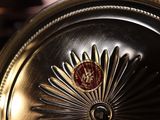 a close up of a clock on a table in a room