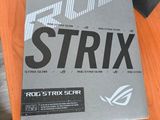 a box of strix next to a laptop on a desk