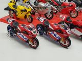 a lot of motorcycles that are lined up on a red mat