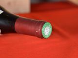 a bottle of wine sitting on a red table cloth