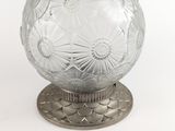 an image of a clear glass ball on a metal stand