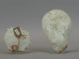 two white vases that are sitting next to each other