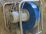 a blue and white blower sitting on the ground next to a red and green fire hydrant