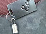 an image of a luggage tag attached to the seat of a car