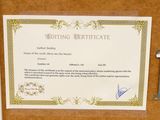 a certificate on a bulletin board with a key