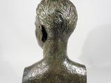 bronze bust of a young man with a short haircut