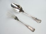 two spoons and a fork sitting on a table