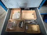 a drawer full of assorted items in a garage
