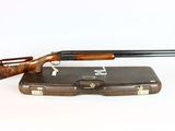 an old rifle with a wooden case on a white background