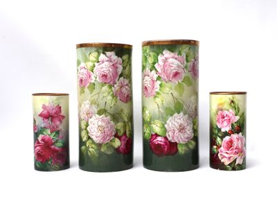 four vases with flowers painted on them on a white background