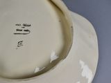 a white plate with writing on it sitting on a table