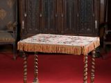 a small table with a cushion on it in the middle of a room