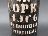an old bottle of liquor with a cork stopper on it