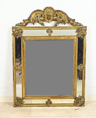 a mirror that is sitting on the floor in front of a wall