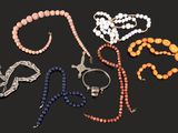 a lot of beads and bracelets on a black background