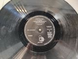 an old record with a label on it sitting on top of a table