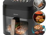 an image of a black air fryer with a variety of food in it