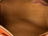 the inside of an orange purse with a zipper on it