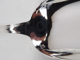 a silver spoon with a black handle sitting on a white surface