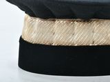 a black hat with a gold band on it