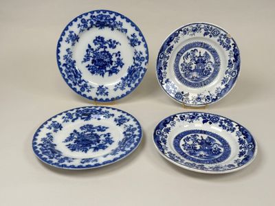 three blue and white plates with floral designs on them