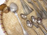 many spoons and spoon spoons laid out on a tray