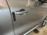 a close up of a car door handle with a sticker on it