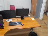 a computer desk with two monitors and a keyboard on it