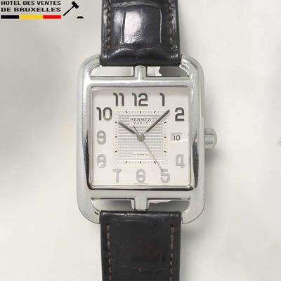 a watch that is sitting on a white surface