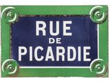 blue and white street sign with white lettering on green background