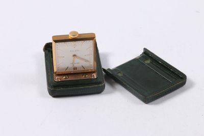 a small square clock sitting on top of a small box