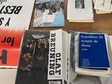 many books on a table that have been placed on top of each other