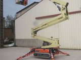 a picture of a man on a cherry picker in front of a building
