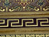 an image of a close up of a leather case with gold and purple designs on it