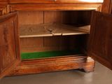 a wooden cabinet with two doors open on the floor