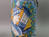 a blue and yellow canister with a picture of a woman on it