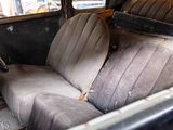 an old car with two seats in the back of it