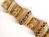 an image of a gold and blue bracelet on a white surface