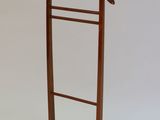 a wooden coat rack with a coat hanger on it