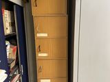 a refrigerator in the middle of a room with a lot of drawers