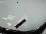 a sticker on the hood of a white car